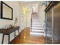 Inviting entryway with hardwood floors, staircase, and a decorative console table at 258 Iverson Way, Charlotte, NC 28203