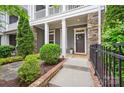 Stylish front entrance with stone accents, a covered porch and manicured landscaping at 258 Iverson Way, Charlotte, NC 28203