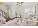 Cozy living room featuring neutral tones, large windows, and elegant decor, with stair access at 258 Iverson Way, Charlotte, NC 28203