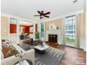Spacious living room with hardwood floors, fireplace, ceiling fan, and natural light at 2825 Redfield Dr, Charlotte, NC 28270