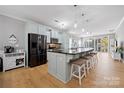 Open kitchen featuring a large island with seating, stainless steel appliances, and stylish pendant lighting at 31226 Cove View Ct, Lancaster, SC 29720