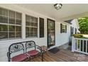 Inviting front porch with seating, black shutters, and a glass front door providing curb appeal at 370 Shiloh Rd, Statesville, NC 28677