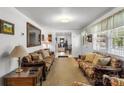 Spacious living room with carpet, sofas, light walls, a large window, and a view into another room at 370 Shiloh Rd, Statesville, NC 28677