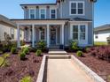 Charming two-story home featuring a welcoming front porch with a swing and a well-manicured landscaped yard at 371 Luray Way, Rock Hill, SC 29730