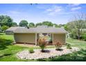 Spacious backyard with a detailed rock garden, a charming pergola, and lush green grass at 374 Queens Sw Dr, Concord, NC 28025