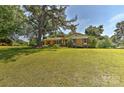 Traditional home with a large front yard and mature trees providing shade and curb appeal at 385 Gum Branch Rd, Charlotte, NC 28214