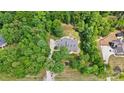 Aerial view of a beautiful home nestled in lush greenery with a circular driveway and well-manicured landscaping at 4570 Chanel Ct, Concord, NC 28025
