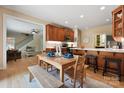 Bright dining area featuring hardwood floors, an open layout, and a breakfast bar adjacent to the well-equipped kitchen at 4570 Chanel Ct, Concord, NC 28025