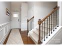 Inviting foyer showcasing hardwood floors, stairs with wood and iron railing and natural light at 5063 Gribble Ln, Lancaster, SC 29720
