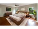 Cozy primary bedroom with hardwood floors, large window, and stylish furnishings at 5075 Meanna Dr, Clover, SC 29710