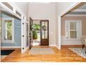 Welcoming foyer with hardwood floors, a transom window and an open view to the outdoors at 5321 Kathryn Blair Ln, Charlotte, NC 28226