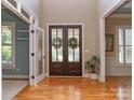 Elegant foyer with hardwood floors, double doors, and natural light at 5321 Kathryn Blair Ln, Charlotte, NC 28226