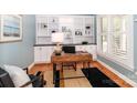 Comfortable home office with custom built-ins, hardwood floors, and natural light at 5321 Kathryn Blair Ln, Charlotte, NC 28226