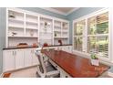 Bright home office with custom built-ins, a large window, and a spacious desk at 5321 Kathryn Blair Ln, Charlotte, NC 28226