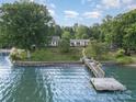 Charming waterfront property with a private wooden dock for easy lake access and relaxation at 565 Shore Acres Rd, Salisbury, NC 28146