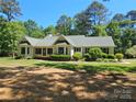Charming ranch-style home with a well-maintained lawn and mature trees providing ample shade at 5903 Wm Griffin Rd, Monroe, NC 28112