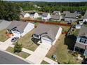 An aerial view of a neighborhood featuring well-maintained homes, green lawns, and mature trees on a sunny day at 6719 Jerimoth Dr, Charlotte, NC 28215