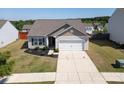 Aerial view of single-story home with manicured lawn, two-car garage, and neat landscaping in a quiet neighborhood at 6719 Jerimoth Dr, Charlotte, NC 28215