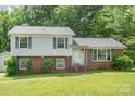 Charming two-story home with brick and vinyl siding and mature landscaping at 7106 Marlbrook Dr, Charlotte, NC 28212