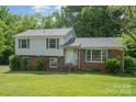 Charming two-story home with brick and vinyl siding and mature landscaping at 7106 Marlbrook Dr, Charlotte, NC 28212