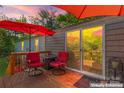 Inviting outdoor deck with cozy seating and umbrella, ideal for enjoying peaceful moments outside the sliding glass door at 743 Dream Ln, Salisbury, NC 28146