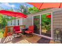 Inviting outdoor deck with cozy seating and umbrella, ideal for enjoying peaceful moments outside the sliding glass door at 743 Dream Ln, Salisbury, NC 28146