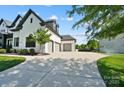 Spacious driveway leading to a three-car garage of a charming white brick home at 1005 Grand Oak Dr, Waxhaw, NC 28173