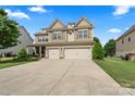 Charming two-story home with a well-manicured lawn and a two-car garage at 1011 Potomac Rd, Indian Trail, NC 28079