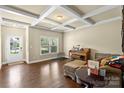 Cozy living room featuring a beautiful coffered ceiling, hardwood floors and a large window at 1011 Potomac Rd, Indian Trail, NC 28079