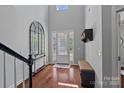 Bright foyer with high ceilings, hardwood floors, and a decorative mirror at 1012 Sudbury Ln, Matthews, NC 28104