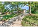 Well-maintained exterior view of the home with a long driveway and mature trees at 1110 16Th Avenue Nw Pl, Hickory, NC 28601