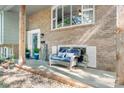 Inviting front porch with a cozy bench, manicured landscaping, and charming welcome decor at 1110 16Th Avenue Nw Pl, Hickory, NC 28601