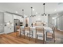 Bright, modern kitchen with stainless steel appliances, quartz countertops, and a large island with barstool seating at 12032 Lavinia Ln, Charlotte, NC 28277