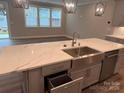 Beautiful island featuring marble countertops, a stainless steel sink, and a dishwasher at 12032 Lavinia Ln, Charlotte, NC 28277