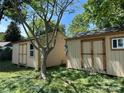 View of backyard storage sheds with windows and double doors, ideal for outdoor equipment and tools at 1212 Meadow Ln, Charlotte, NC 28205