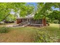 Welcoming brick home featuring a covered front porch with ramp and well-maintained lawn at 1233 E Cannon Ave, Albemarle, NC 28001