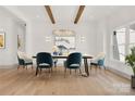 Elegant dining room with stylish chairs, hardwood floors, wood beams, and modern lighting at 124 Clipper Ln, Mooresville, NC 28117