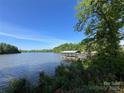 Beautiful lake view showcasing a covered dock, perfect for enjoying waterfront living and recreational activities at 124 Clipper Ln, Mooresville, NC 28117