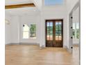 Bright entryway featuring wood floors, a wooden beam and a large front door at 124 Clipper Ln, Mooresville, NC 28117