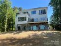 Modern home exterior featuring multiple balconies, large windows, and a stylish design on a well-maintained lot at 124 Clipper Ln, Mooresville, NC 28117