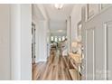 Inviting entryway with hardwood floors, a console table, and views into the living spaces at 1260 Thomas Knapp Pkwy, Fort Mill, SC 29715