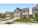 Charming two-story home with neutral siding, stone accents, and a manicured lawn in a suburban neighborhood at 128 Championship Dr, Mooresville, NC 28115