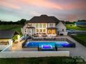 Lovely backyard with inground pool, spa, outdoor kitchen and living spaces, and manicured lawn at 1351 Highway 324 None, Rock Hill, SC 29730