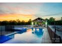 Sparkling pool and spa area with outdoor kitchen and fireplace, perfect for entertaining or relaxing at 1351 Highway 324 None, Rock Hill, SC 29730