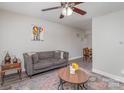 Cozy living room with hardwood-style floors, neutral walls, ceiling fan, and ample natural light at 1512 Seigle Ave # 2, Charlotte, NC 28205