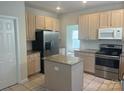 Functional kitchen with granite countertops, stainless steel appliances, and a convenient center island at 16017 Woodcote Dr, Huntersville, NC 28078