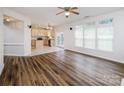 Open floor plan with hardwood flooring, connecting living room to the kitchen with an eat-in island at 16017 Woodcote Dr, Huntersville, NC 28078