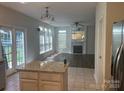 Open-concept living area featuring a fireplace, backyard access, and seamless integration with the kitchen at 16017 Woodcote Dr, Huntersville, NC 28078