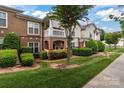Charming townhome with manicured lawn and inviting covered entrance in a well-maintained community at 16610 Amberside E Rd, Cornelius, NC 28031