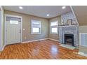 Cozy living room featuring wood floors, a brick fireplace, and natural light at 209 W Marsh St, Salisbury, NC 28144